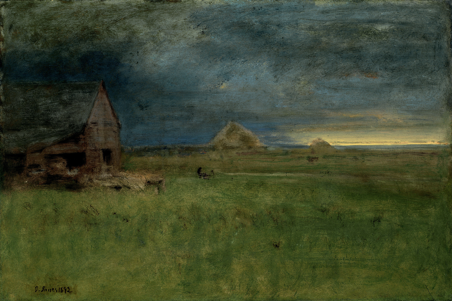 Auto-generated description: A rustic barn stands on a green field under a dramatic, overcast sky with a sliver of light on the horizon.